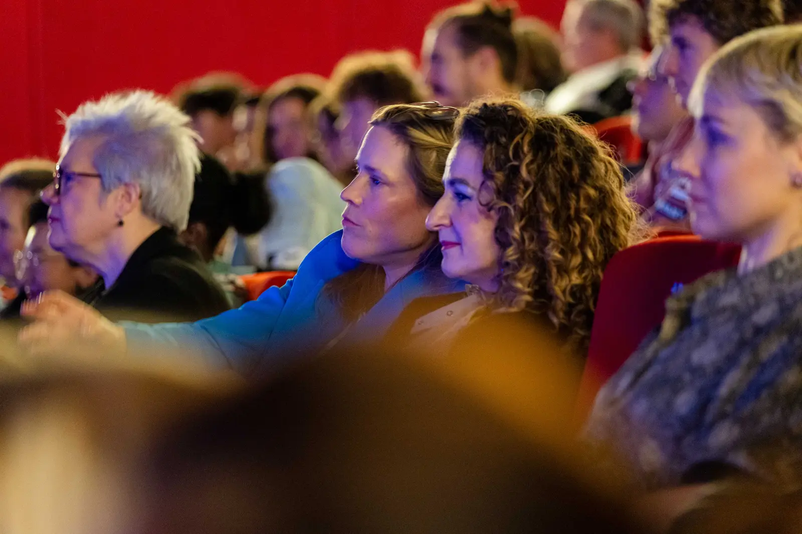Close-up of attentive faces in the audience