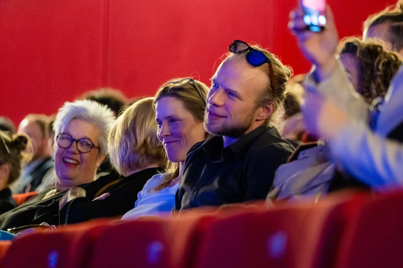 Guests laughing together in the front rows